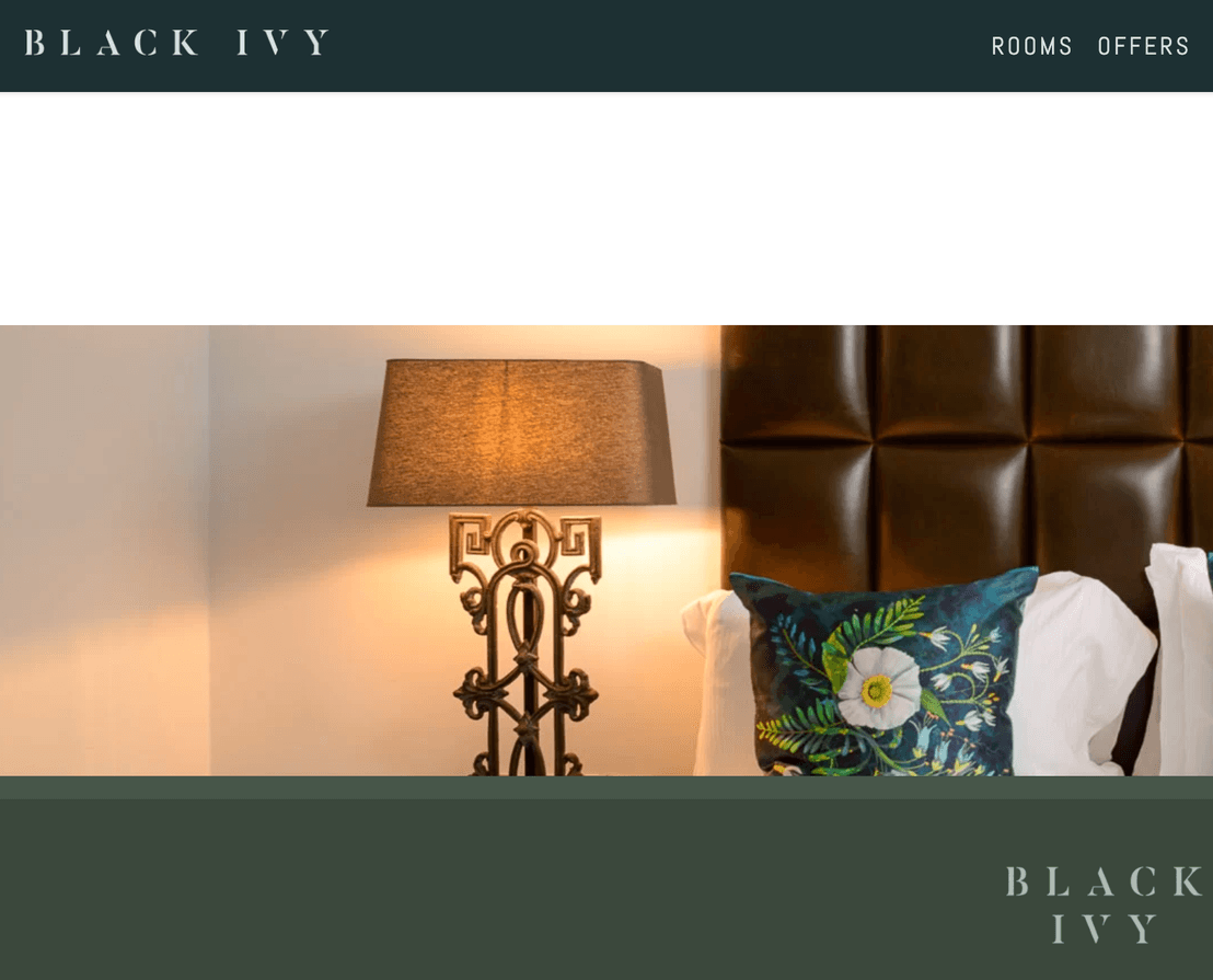 The Black Ivy homepage, with the hotel wordmark, rooms and offers navigation, and a photograph of a guest room